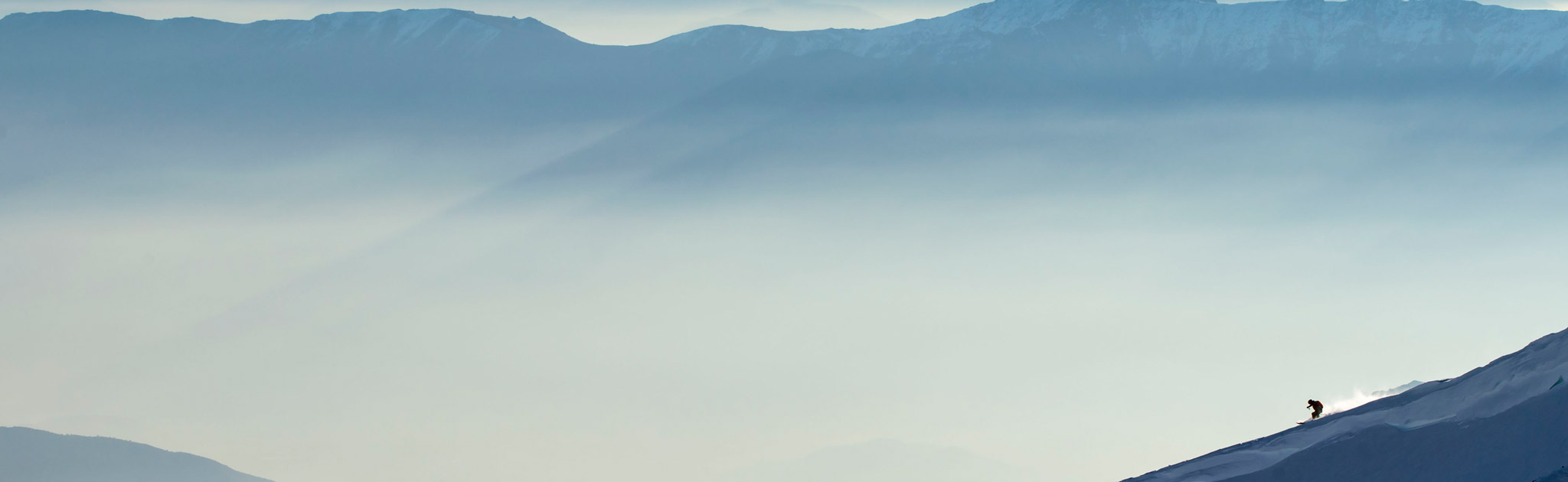 A skier takes a run above the clouds at Ski Arpa. Photo by Michael Neumann, courtesy of Upscape Travel.