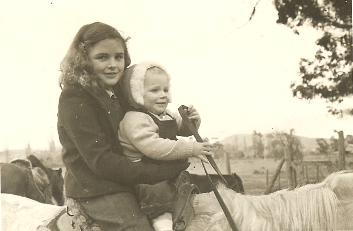 Susan practices for her future as a rodeo rider while baby Sally holds the reins.