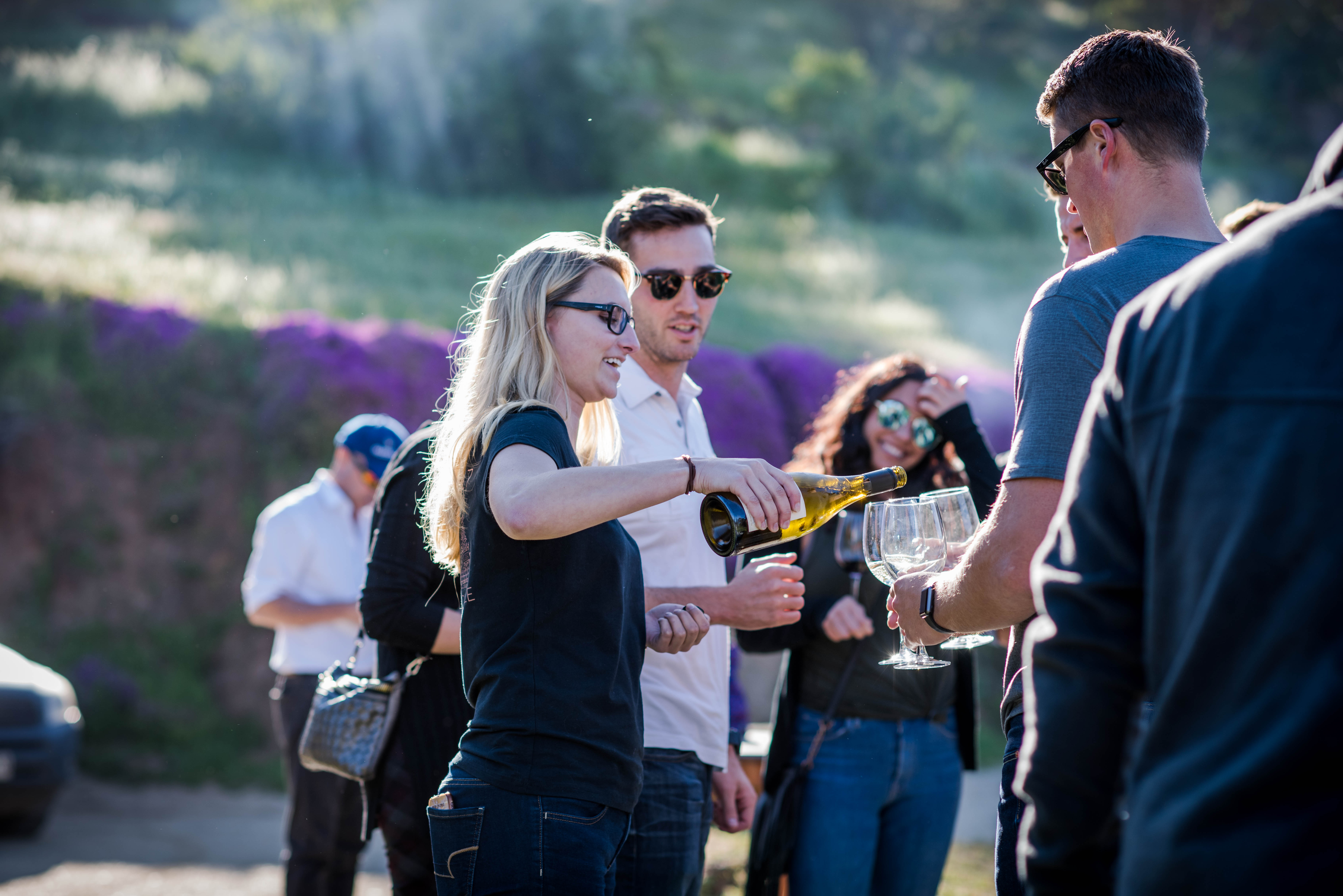 Taylor sharing Cariblanco Sauvignon Blanco with guests.