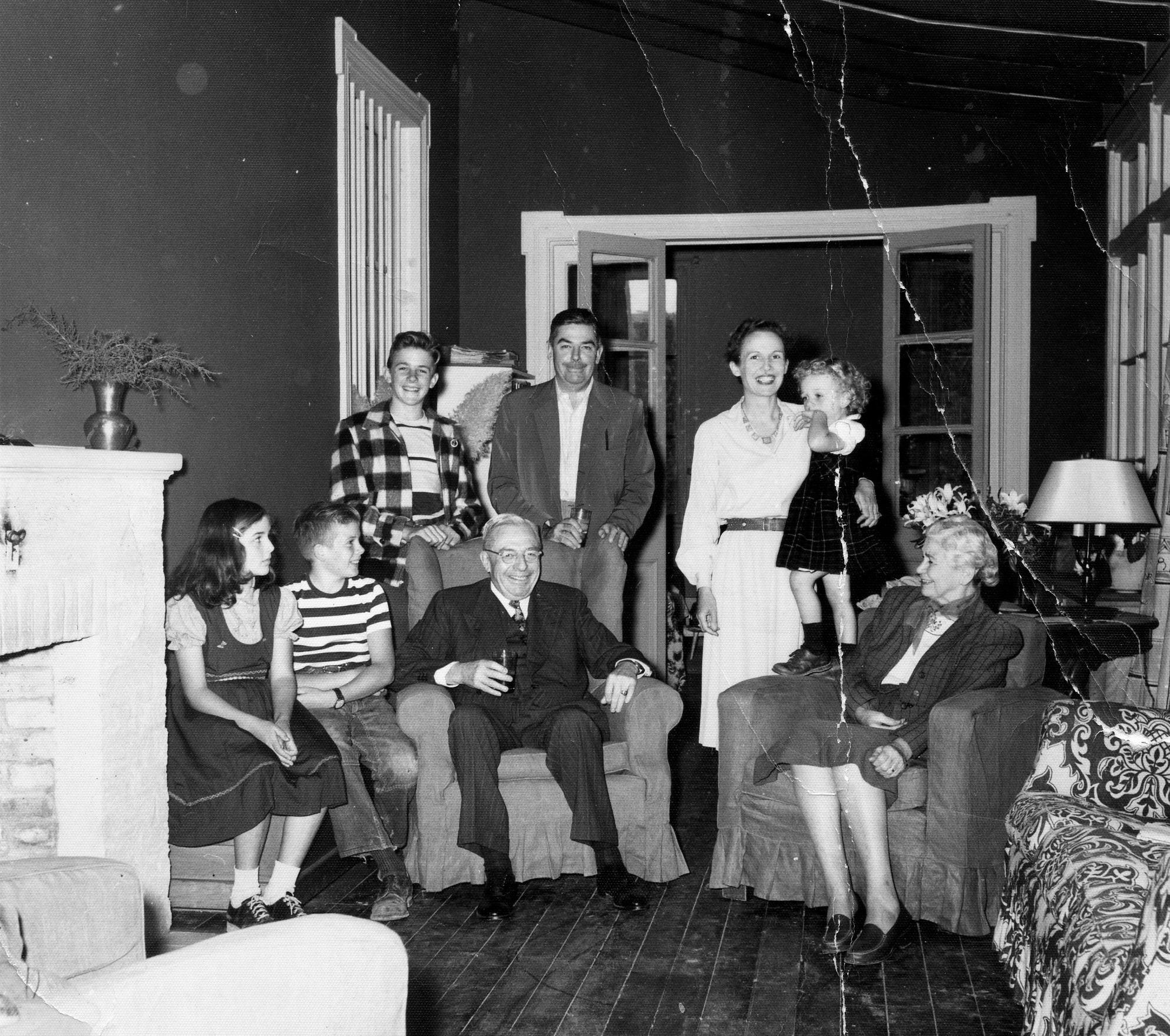 Three generations sit by the fireplace, which was the only source of heat.  From left to right: Susan, Michael, Peter, CJ Kingston, John & Janet Kingston, Sally, Caroline Kingston.