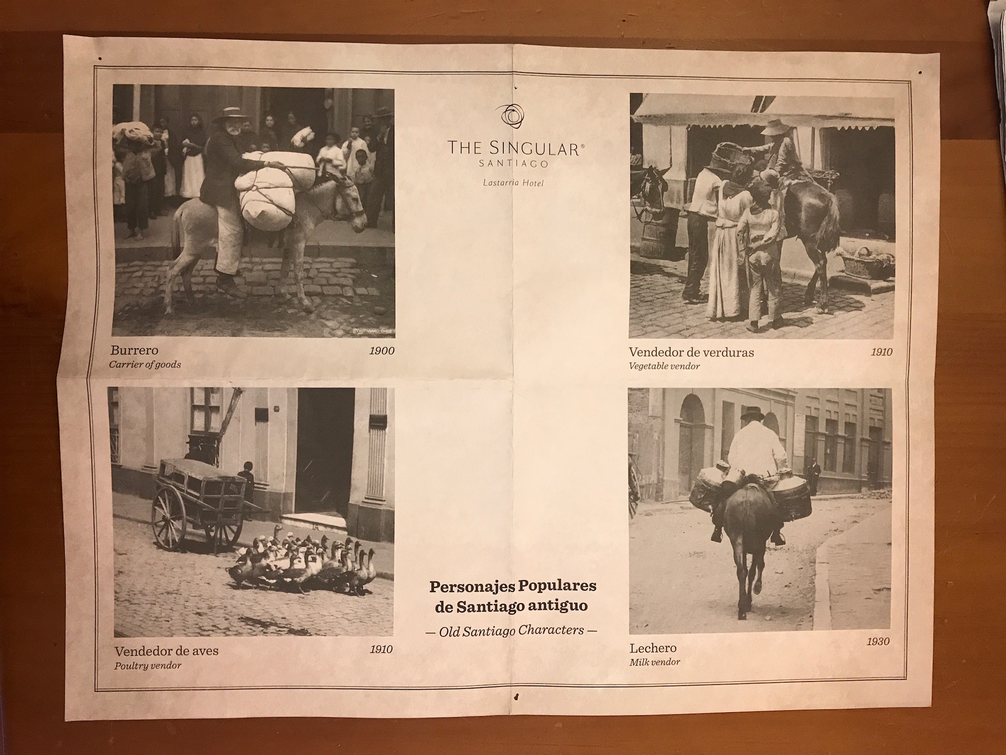 A placemat from The Singular, in Spanish and English, displays old photos of food vendors.