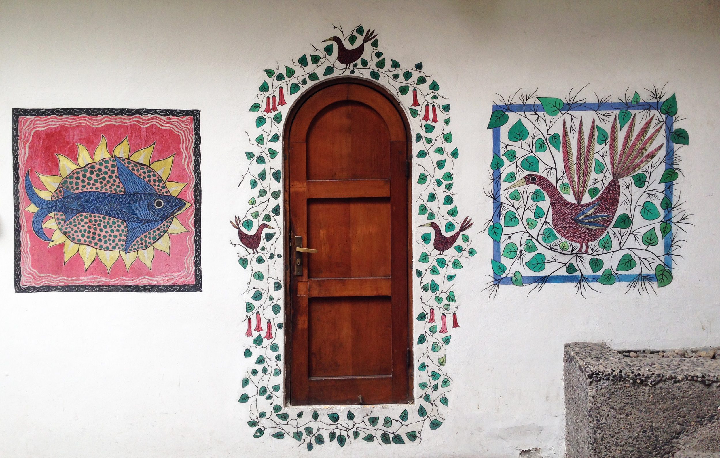Colorful paintings decorate a wall in Barrio Italia.
