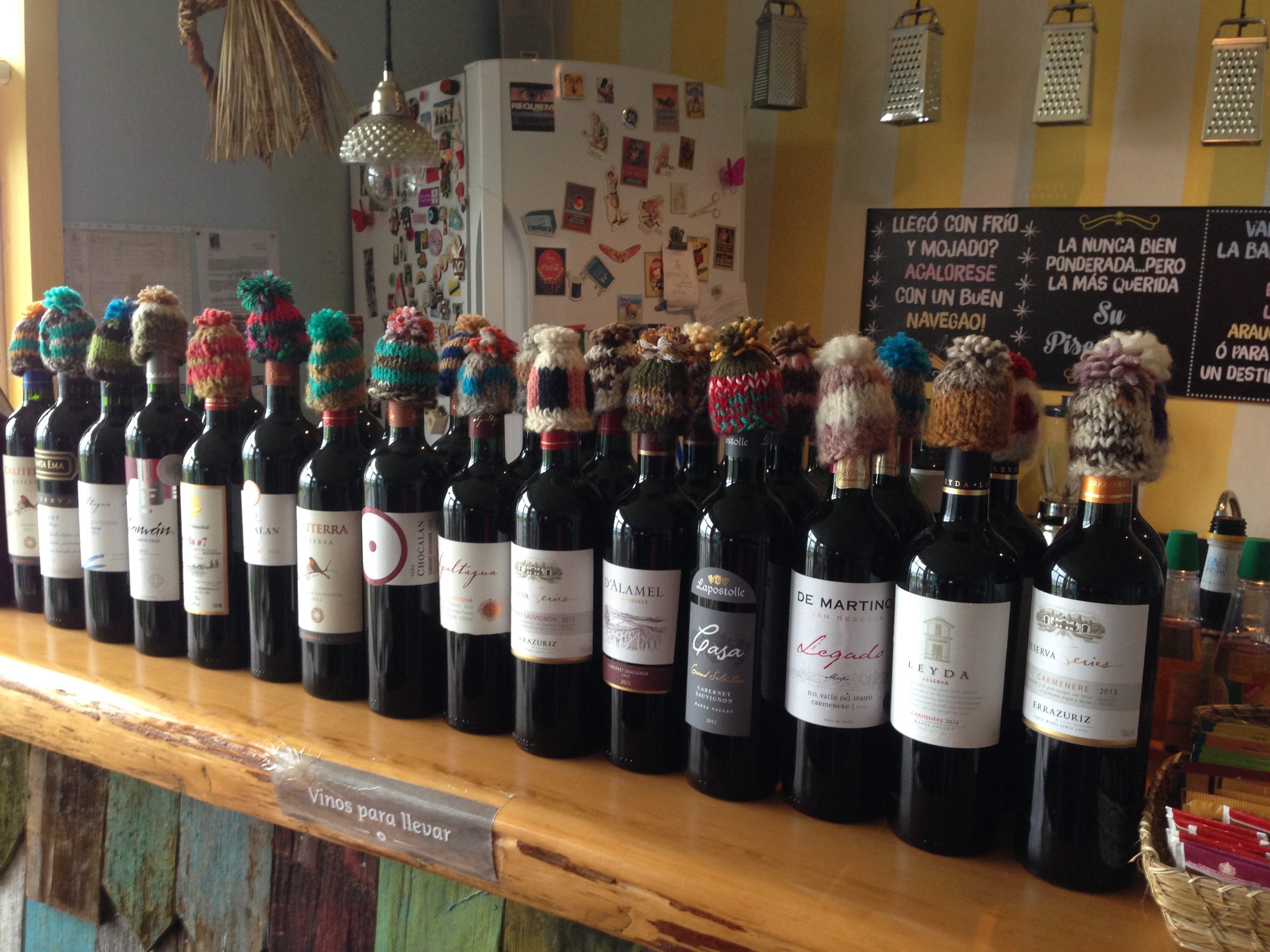 Woolen caps add a touch of quirky flair to wine bottles in Chiloé.