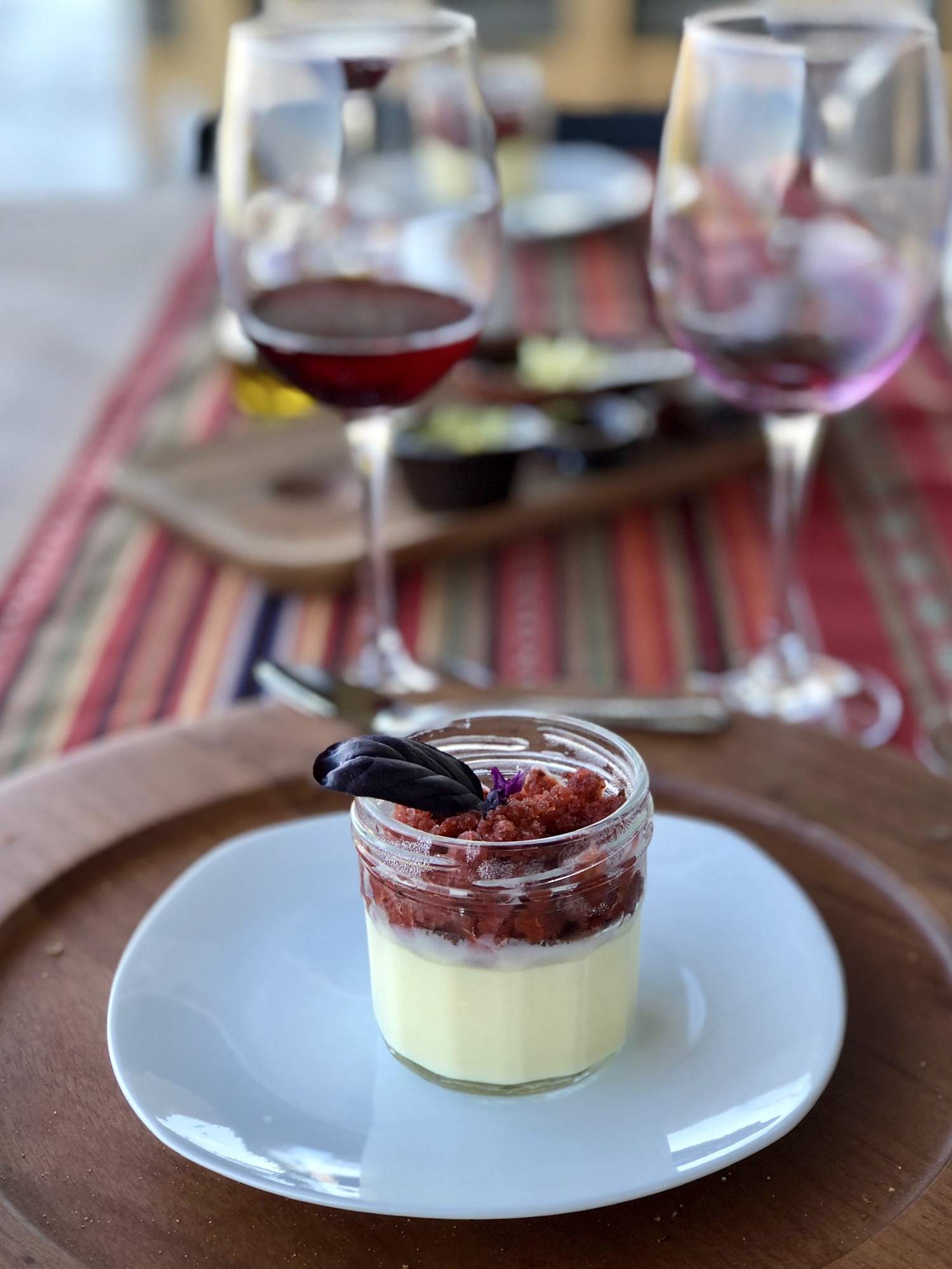 White chocolate pot de creme topped with a Thai basil and strawberry granita. 